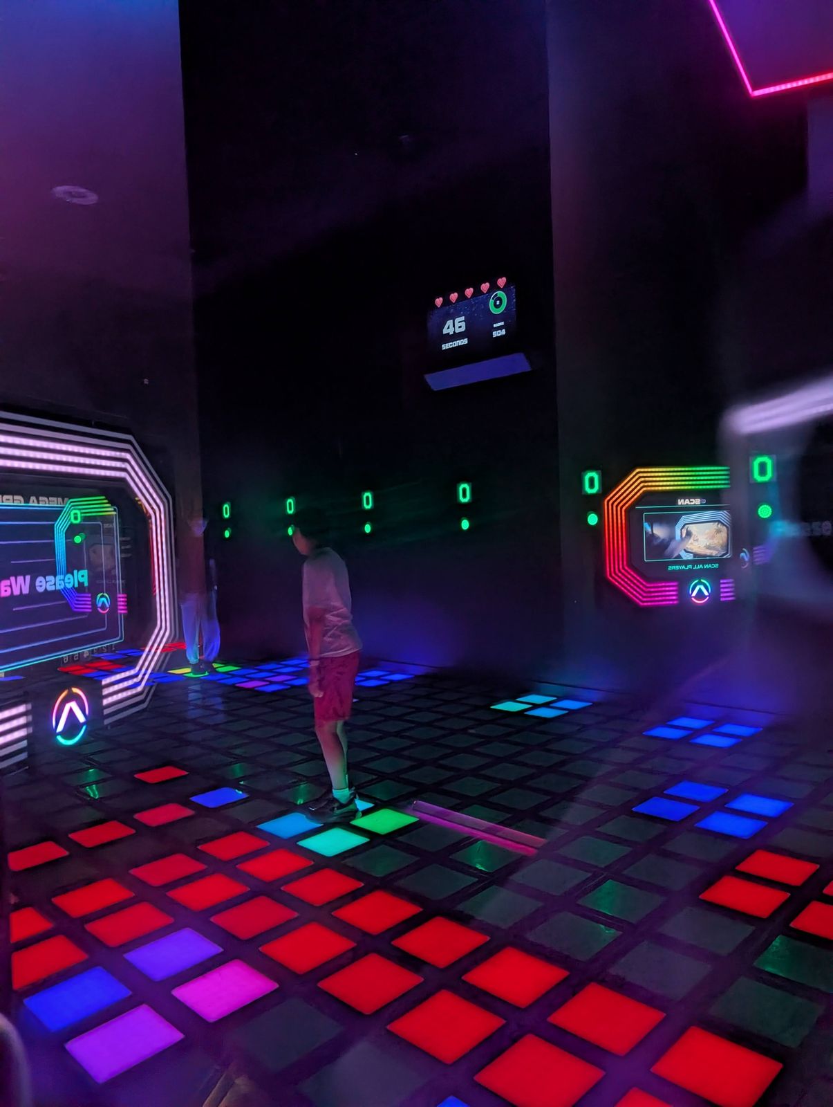 Player on the light-up floor tiles in the Activate Games Grid room