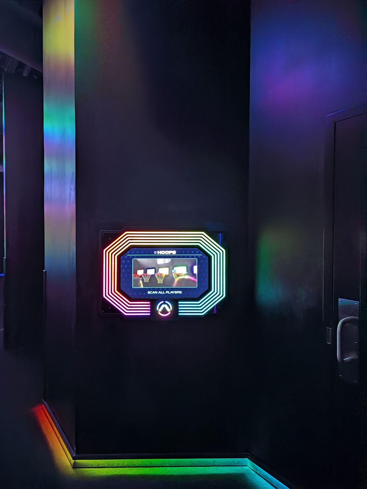 Glowing wristband scan panel outside an Activate game room