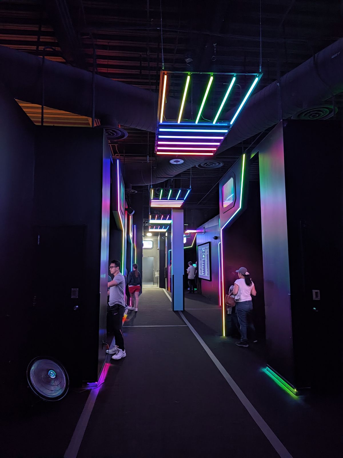 Players walking between game rooms in the Activate Tustin hallway
