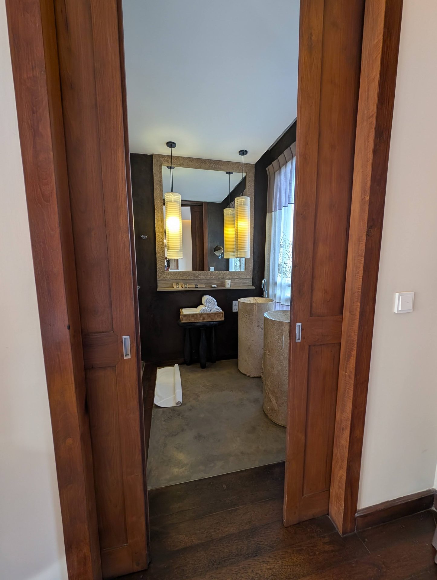 Bathroom with stone basins behind sliding wooden doors at Anantaya Pasikudah