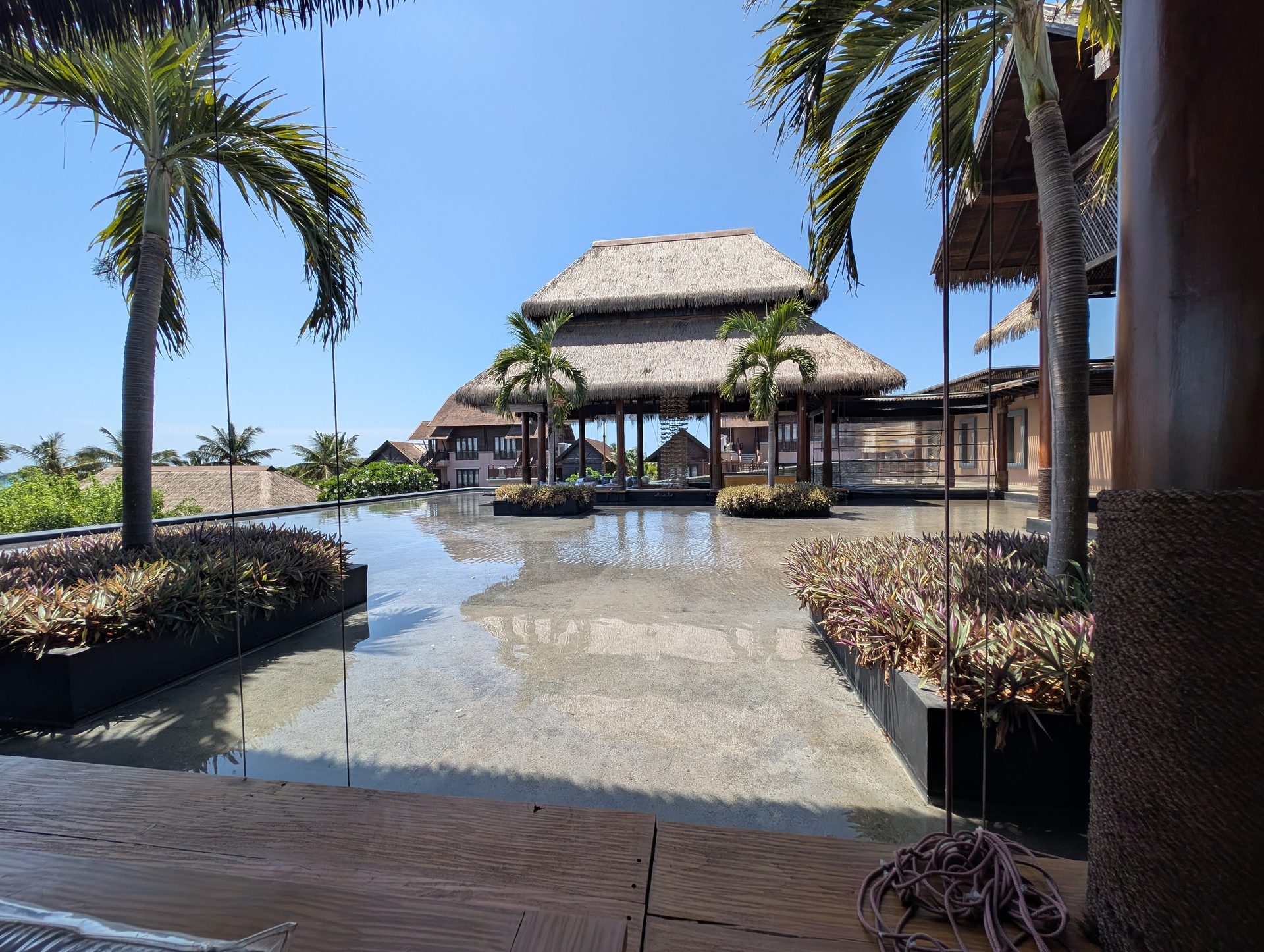 Thatched pavilions and reflecting pool at the Anantaya Pasikudah lobby