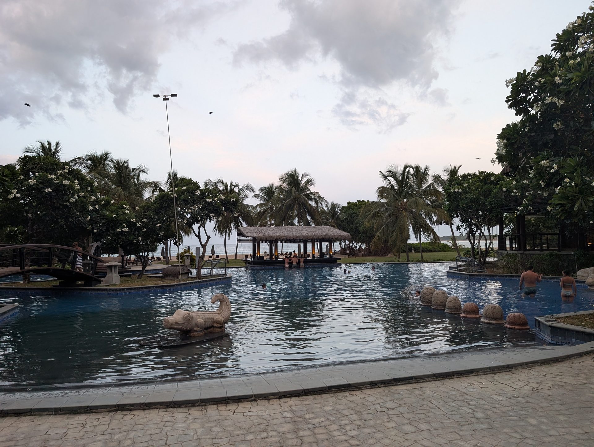Anantaya Pasikudah pool and swim-up bar in the evening