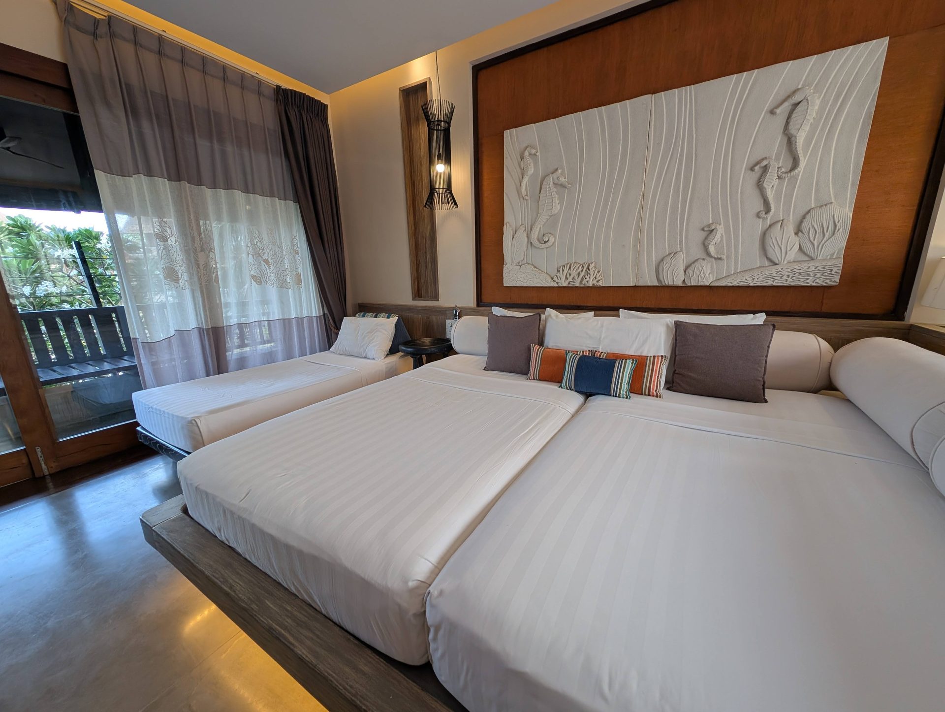 Beds with a carved wall panel in a Superior Room at Anantaya Pasikudah