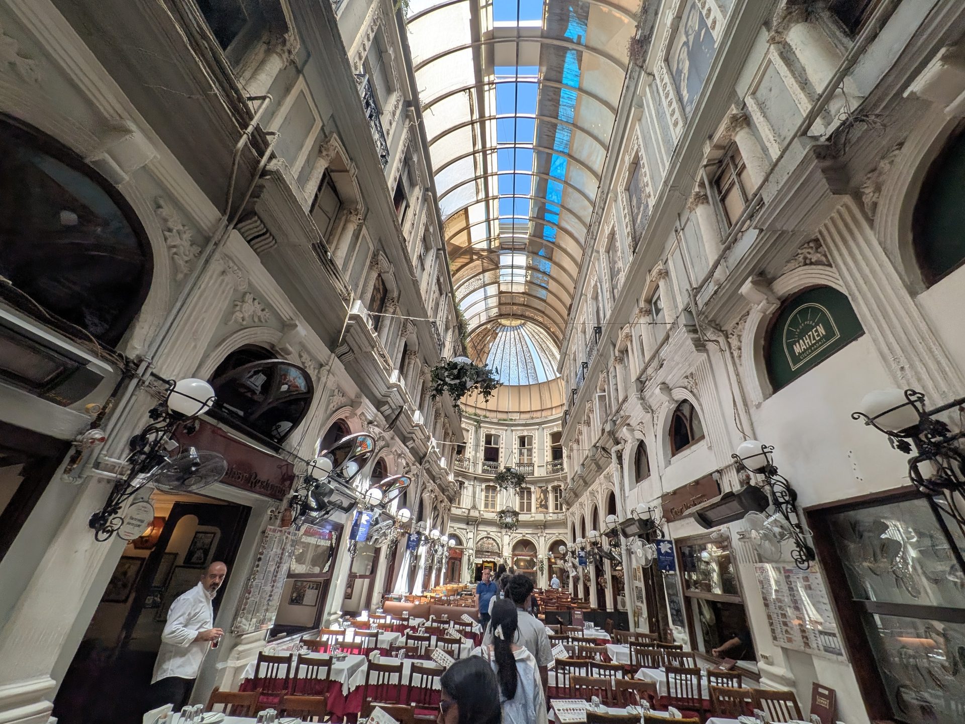 Restaurant tables under the glass roof of Çiçek Pasajı