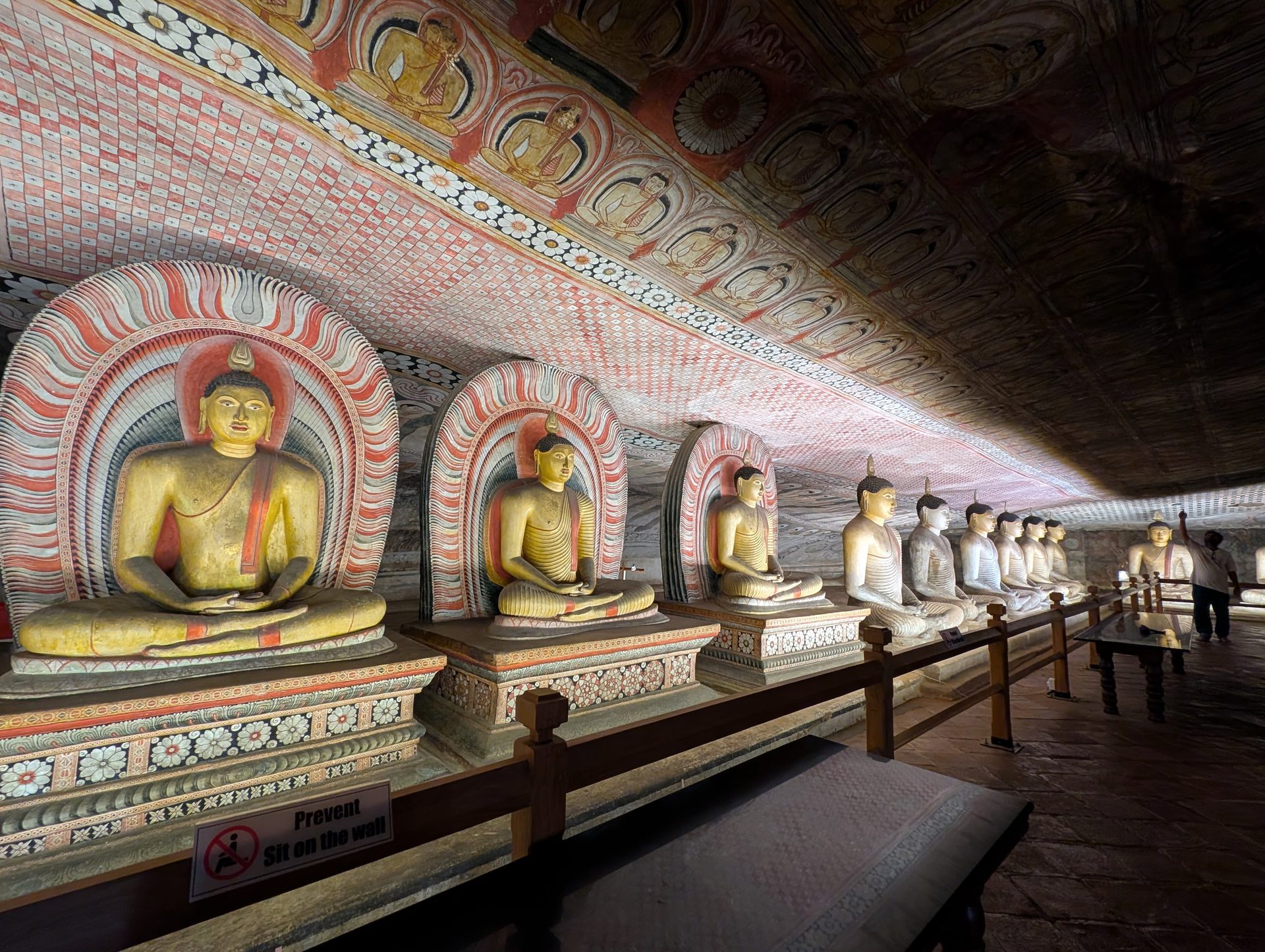 Golden seated Buddhas inside Dambulla Cave Temple