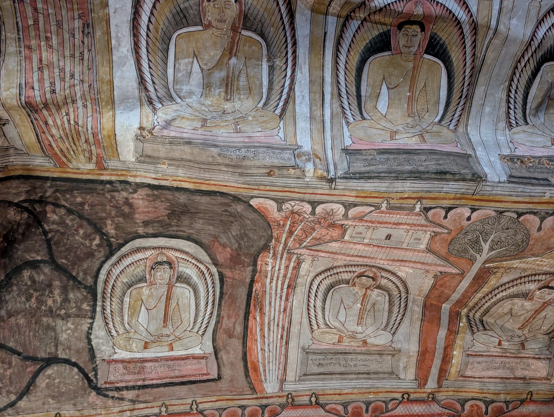 Detailed murals of seated Buddhas at Dambulla