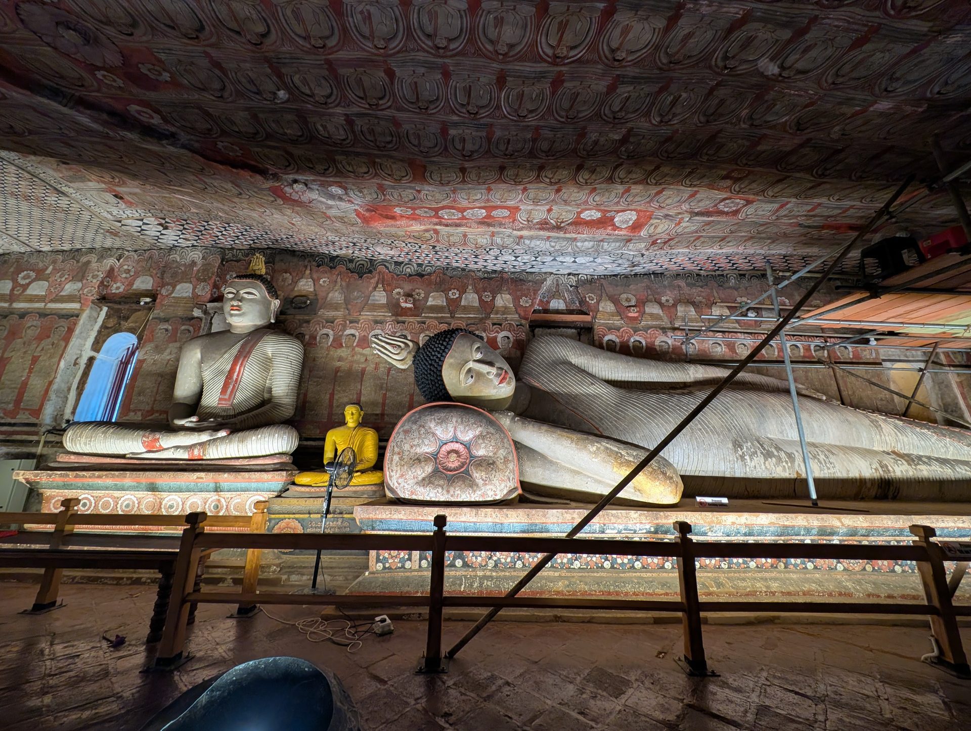 Reclining and seated Buddhas inside a Dambulla cave