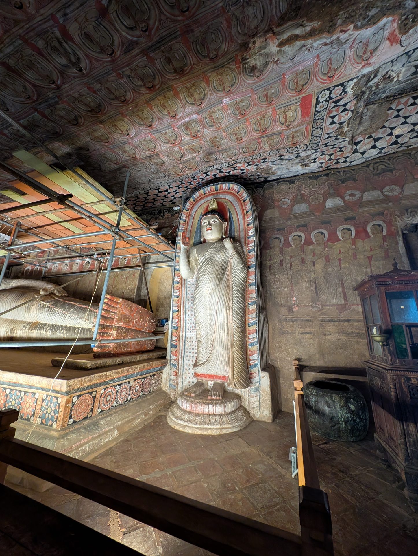 Standing Buddha statue inside a Dambulla cave