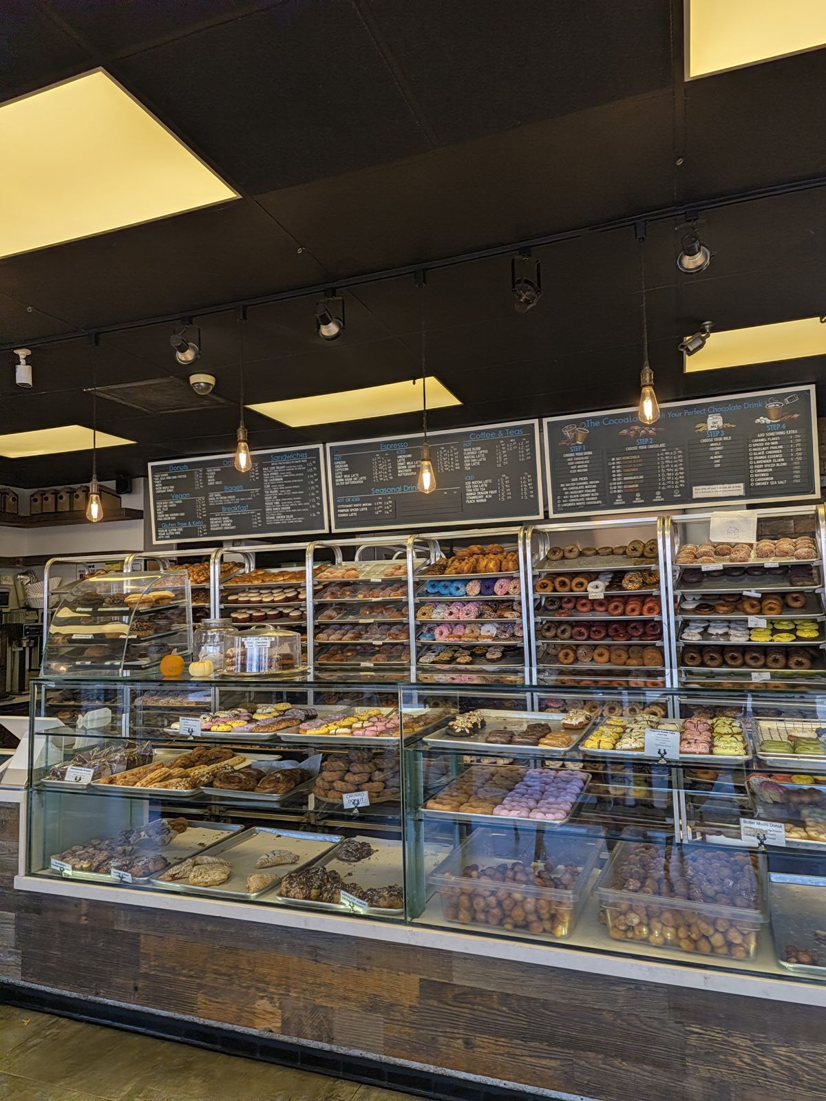 Rows of donuts behind glass at The Donuttery in Huntington Beach