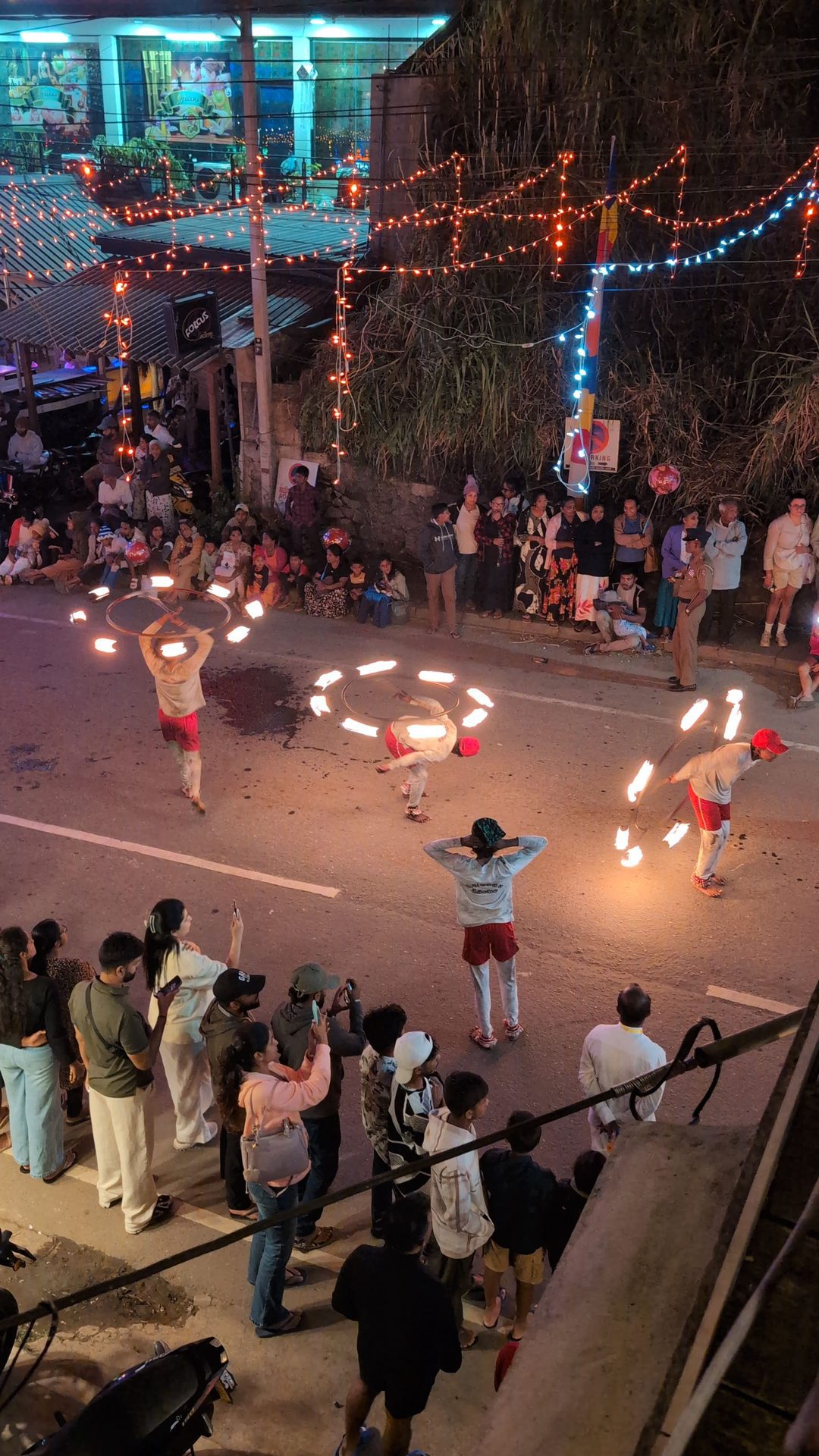 Fire dancers spinning flaming hoops at the Ella perahera