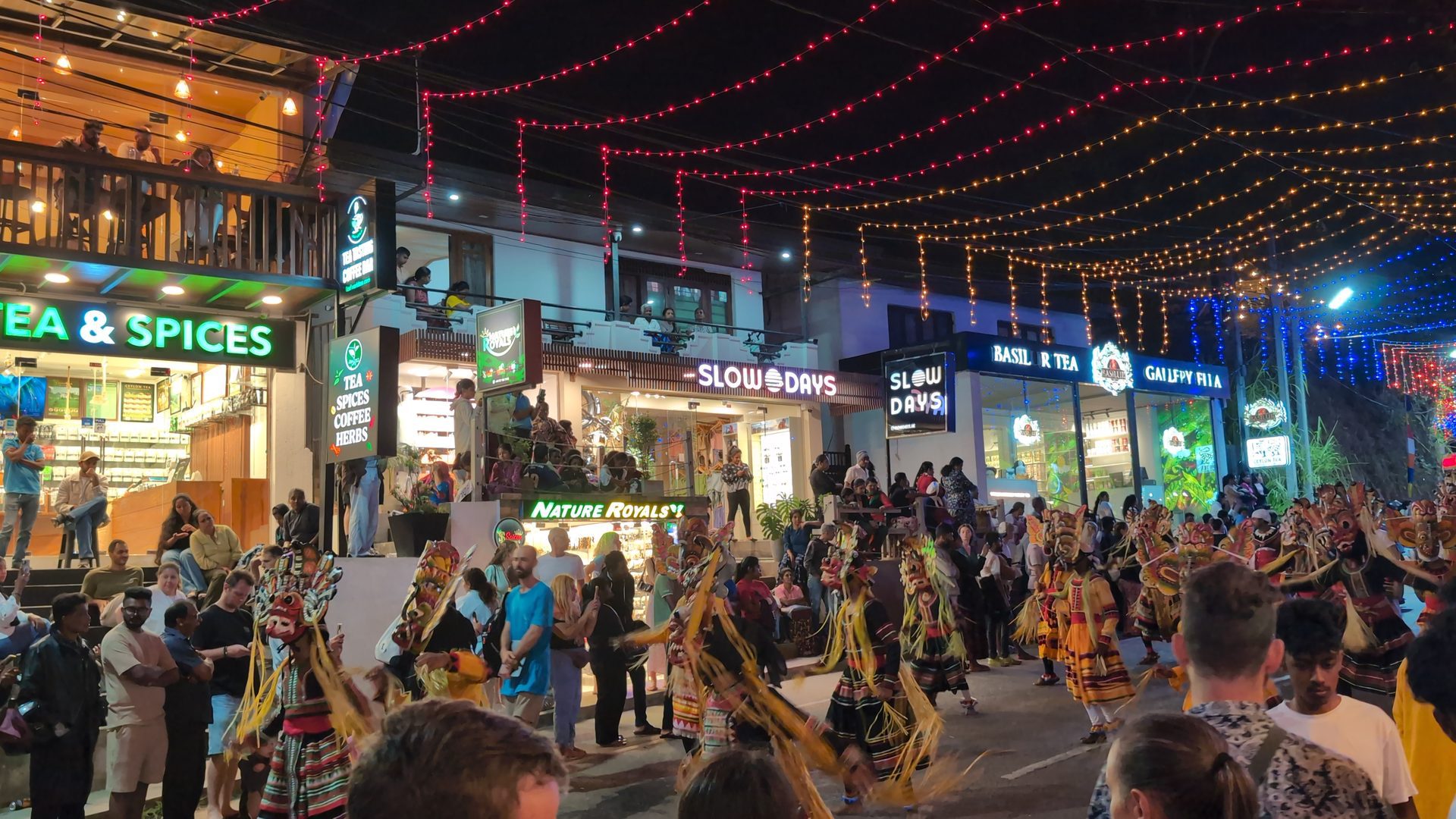 Masked dancers in the street during the Ella perahera