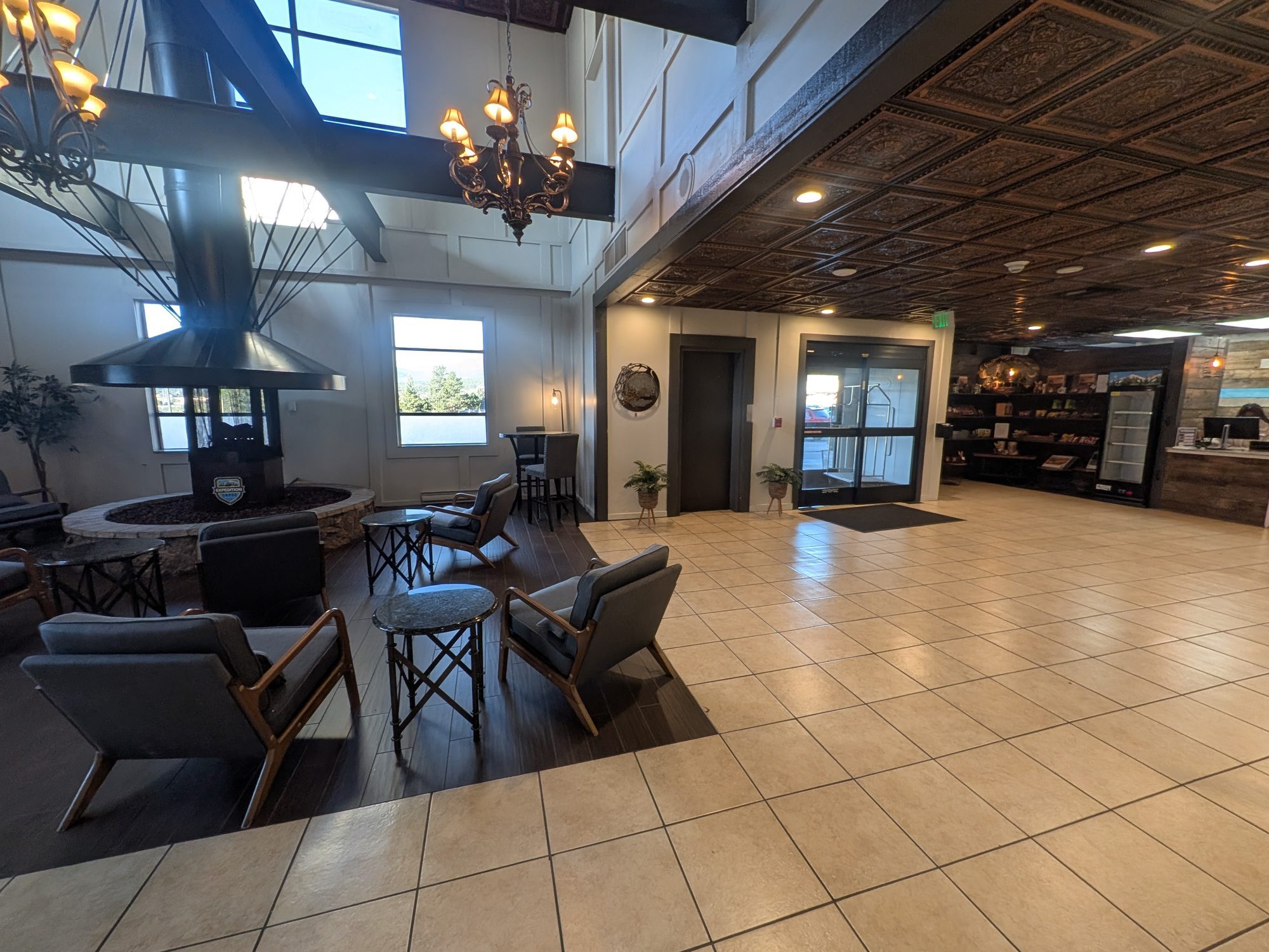 Lobby at Expedition Lodge Estes Park with fireplace seating