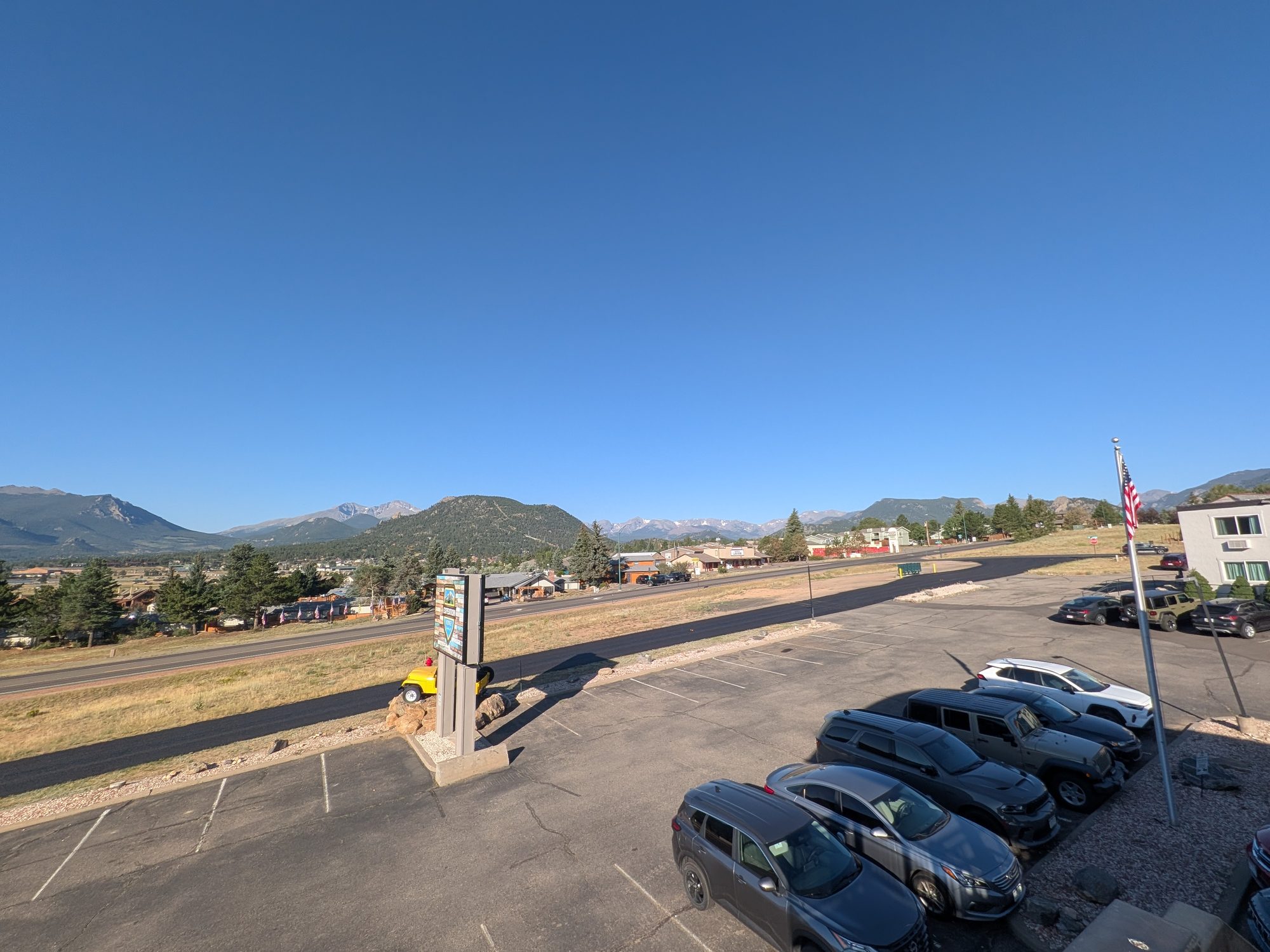 Mountain view over the Expedition Lodge Estes Park parking lot and grounds in morning light
