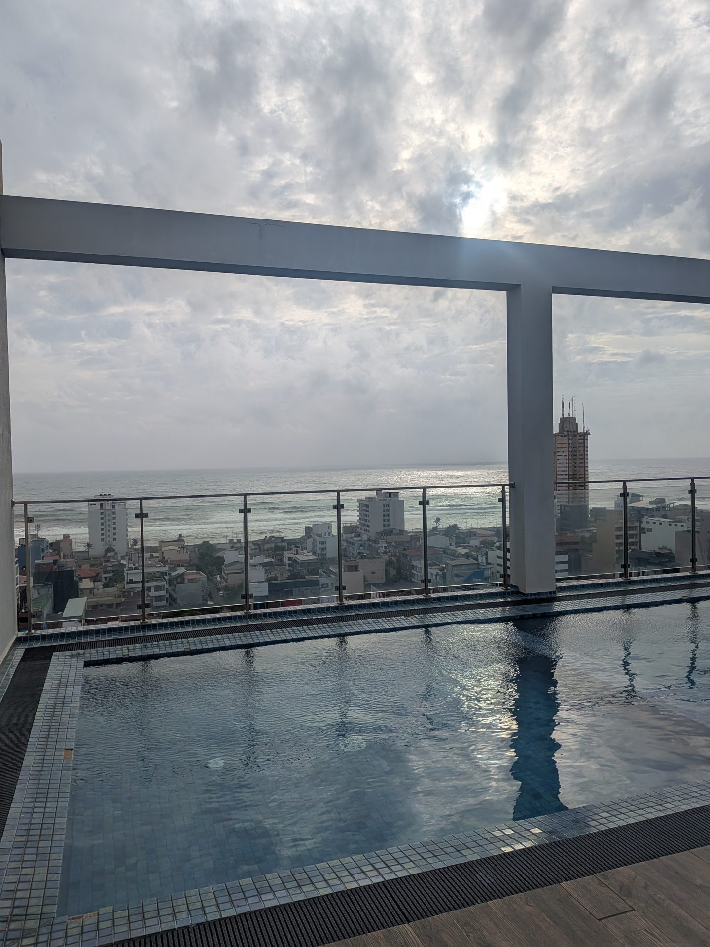 Rooftop infinity pool at The Flemington apartments with an ocean view in Colombo
