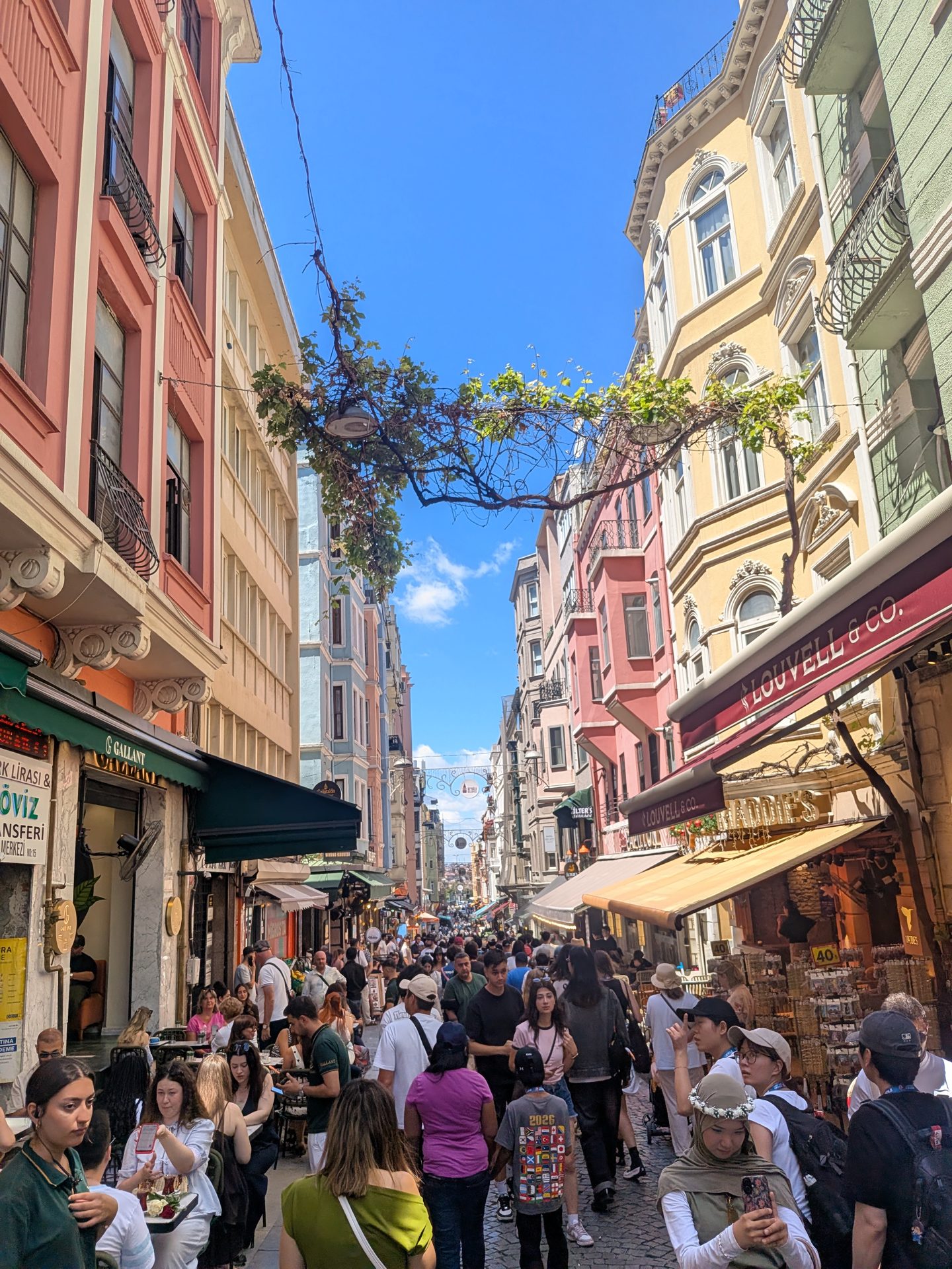 Busy shopping street with colorful buildings near Galata Tower