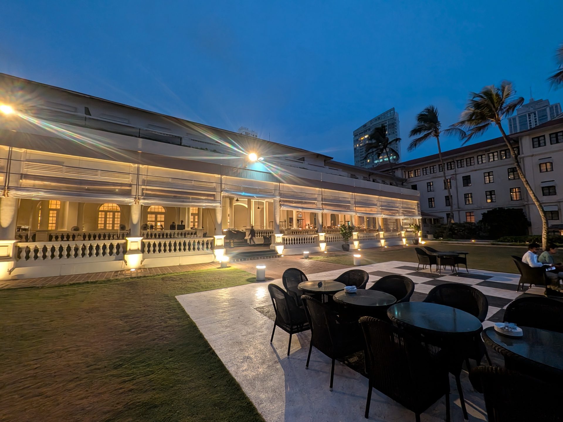 The black-and-white Chequerboard terrace at the Galle Face Hotel at dusk