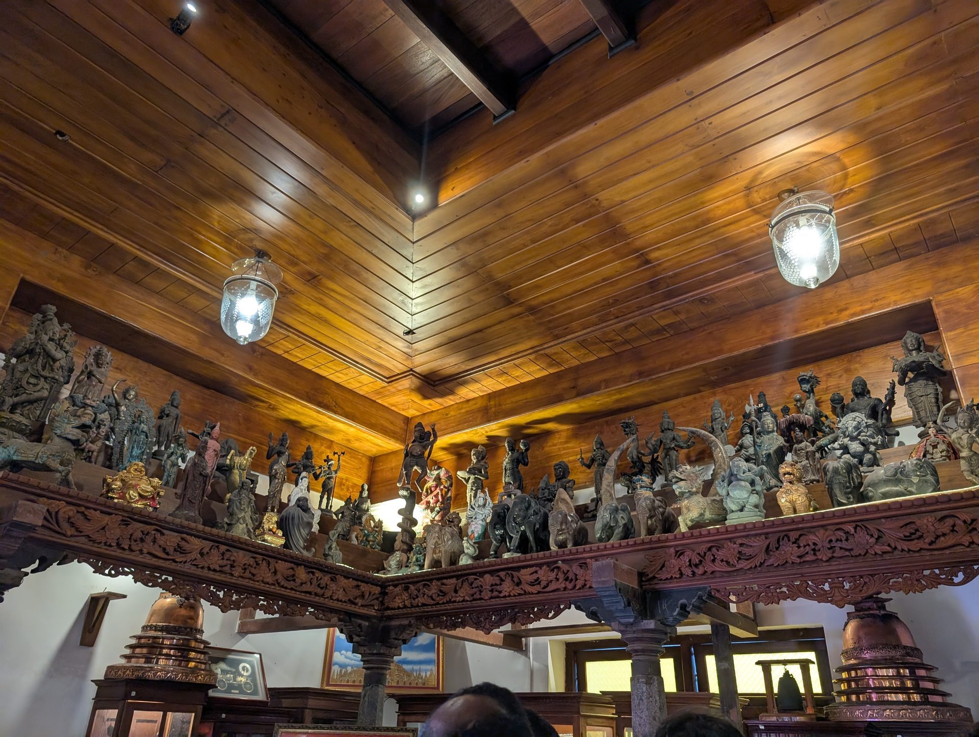 Carved wooden ceiling and statue collection at Gangaramaya Temple