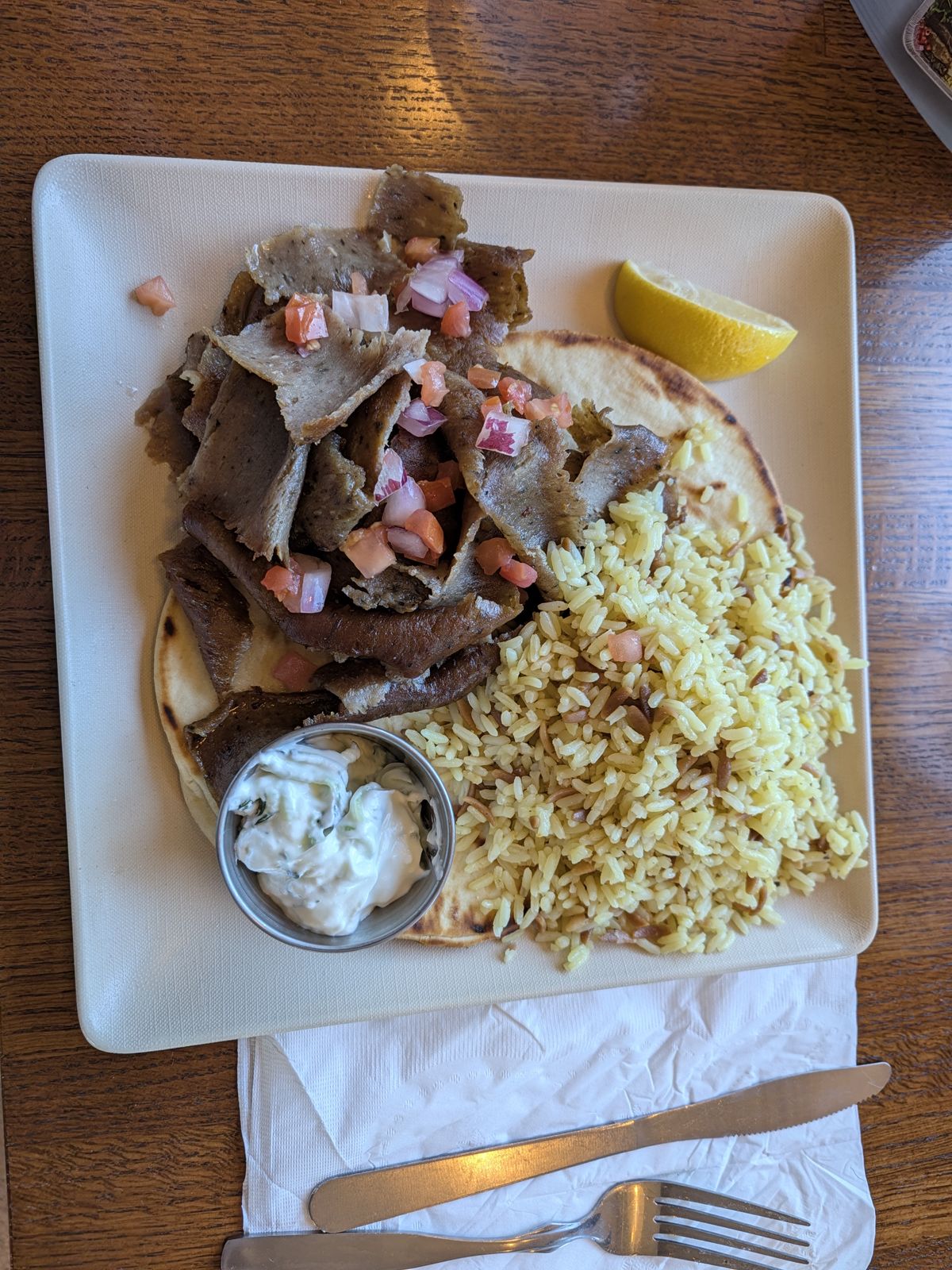 Overhead view of a gyro plate with rice and tzatziki at The Great Greek Irvine