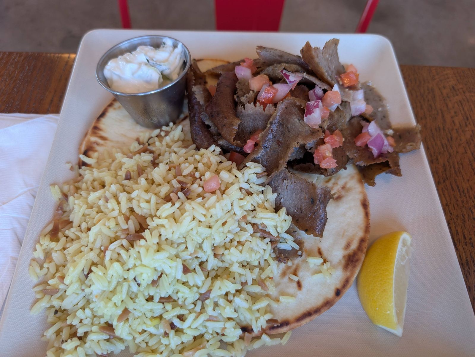 Gyro plate with rice pilaf, pita, tzatziki and lemon
