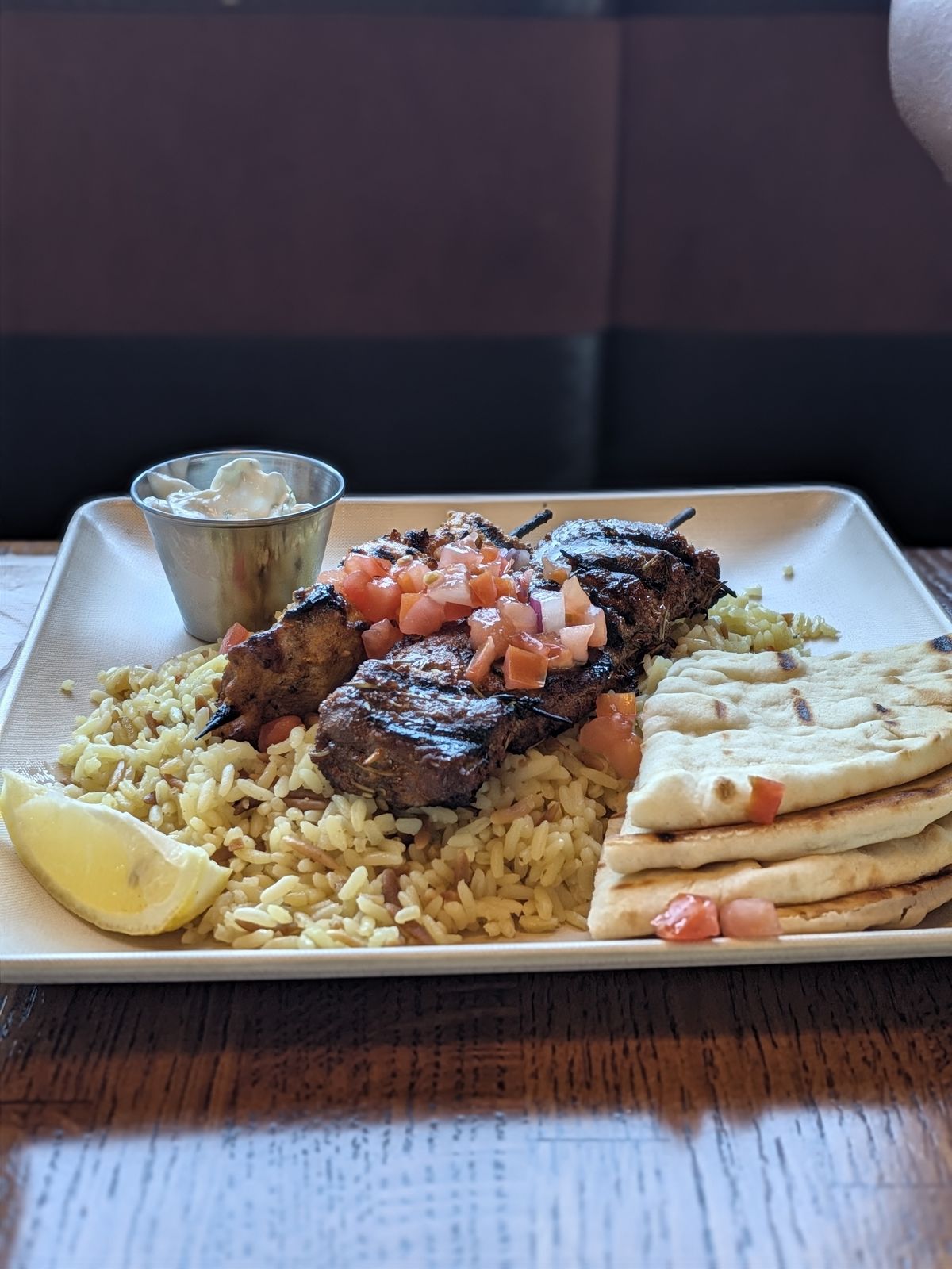 Lamb souvlaki kabob plate with rice pilaf and grilled pita