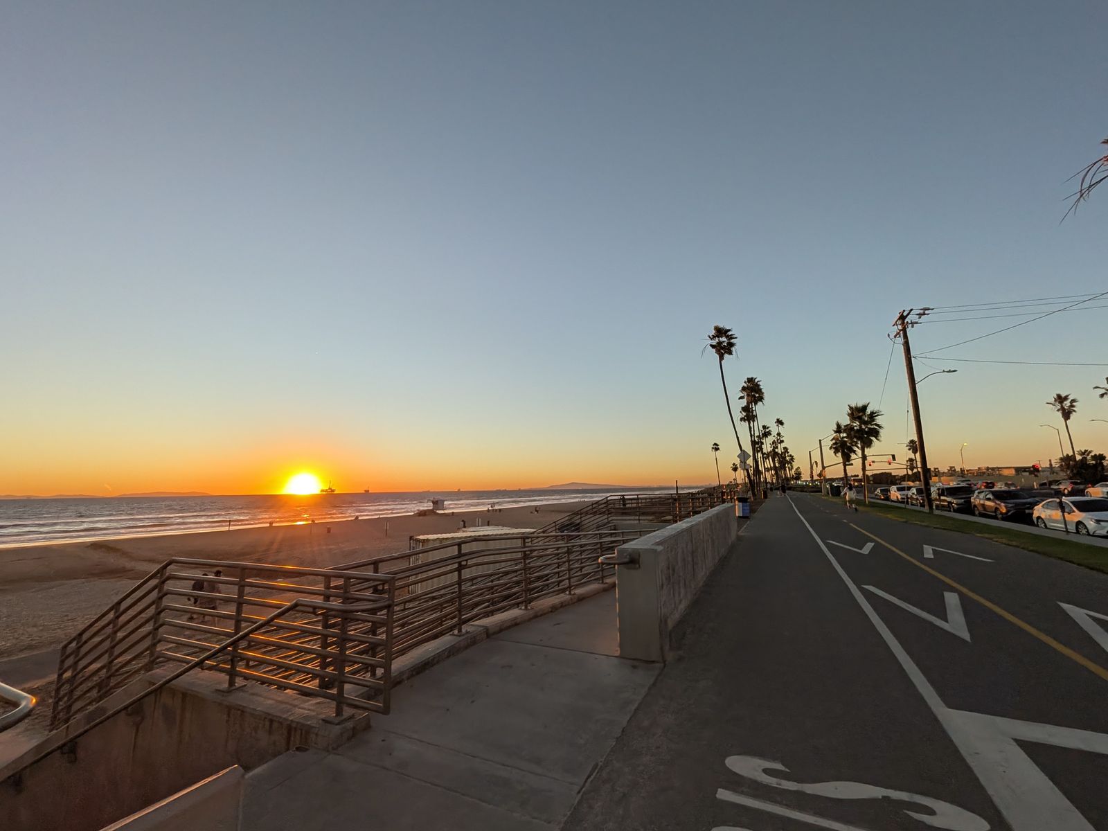 Huntington Beach bike path and stairs to the sand at sunset