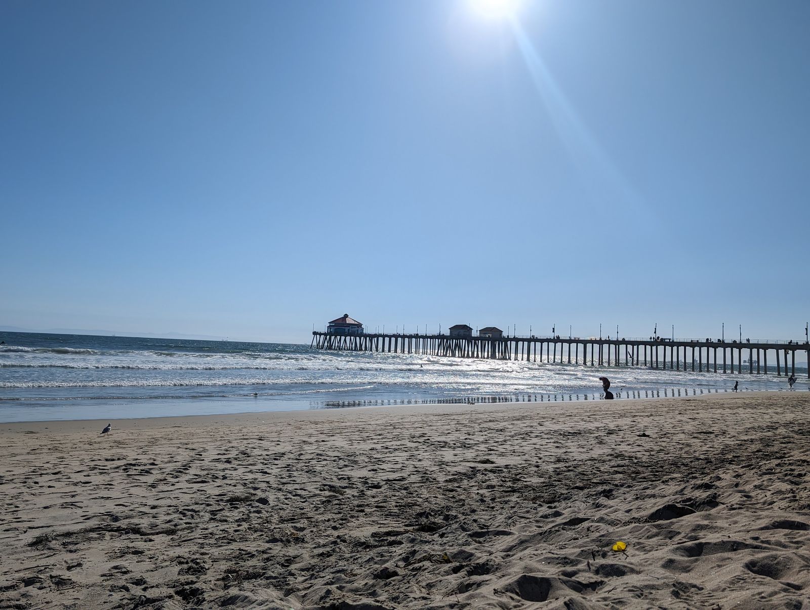 Huntington Beach Pier stretching out over the ocean in the afternoon