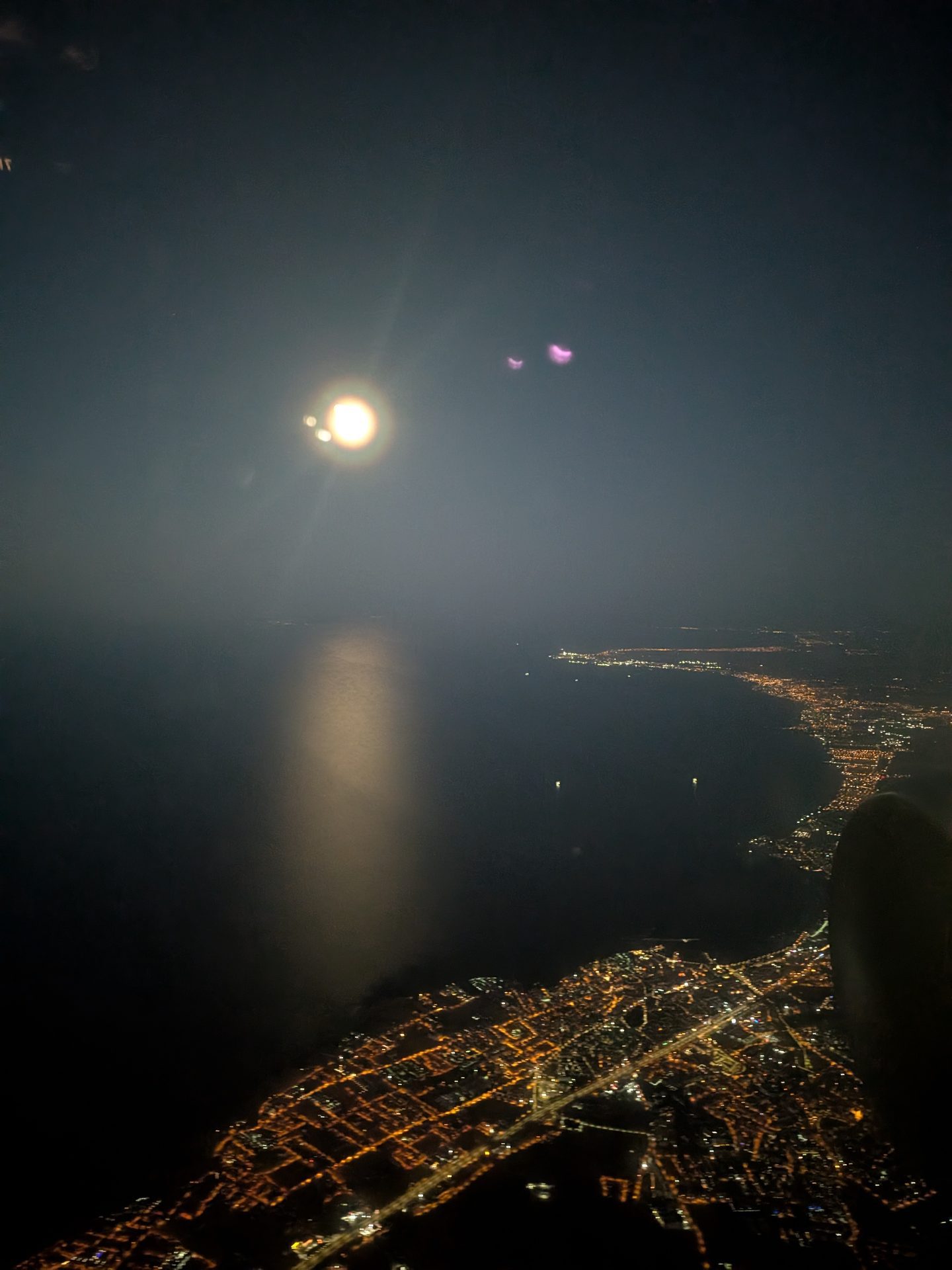 Istanbul city lights and the sea before dawn from the plane