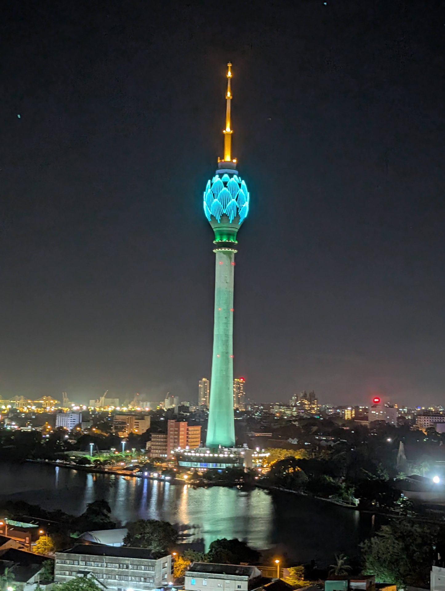 Lotus Tower lit blue at night over Beira Lake