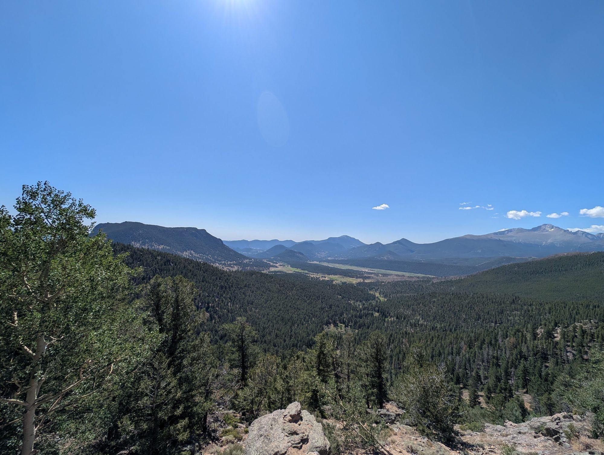 View over forested valleys and distant peaks from Many Parks Curve Overlook on Trail Ridge Road