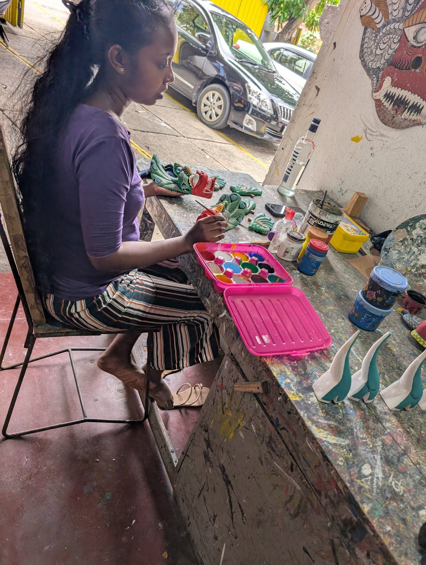 Artisan painting a traditional mask in Ambalangoda