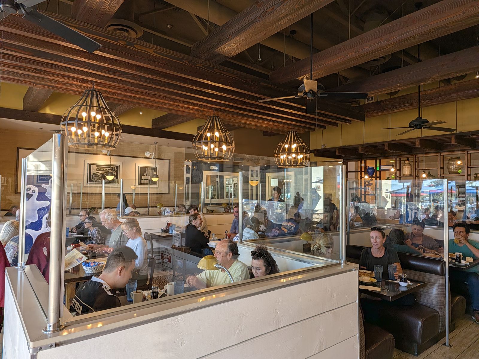 Busy dining room with booths and wood ceiling at The Original Pancake House Huntington Beach
