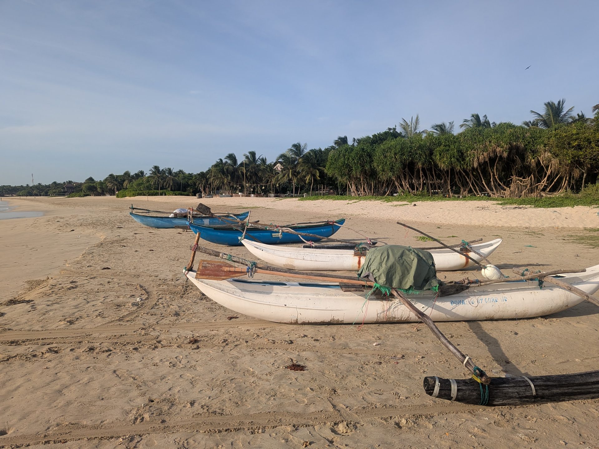Traditional outrigger canoes on the beach at Pasikudah