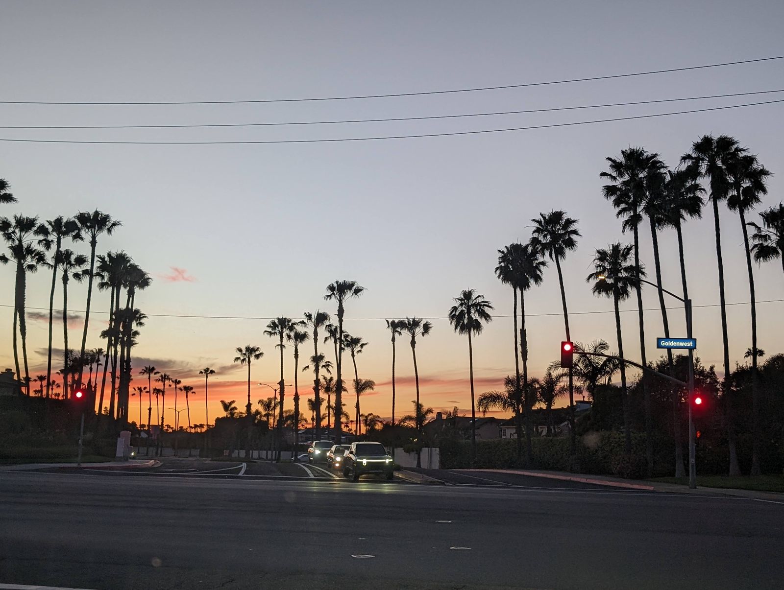Palm trees silhouetted at sunset along Pacific Coast Highway in Huntington Beach