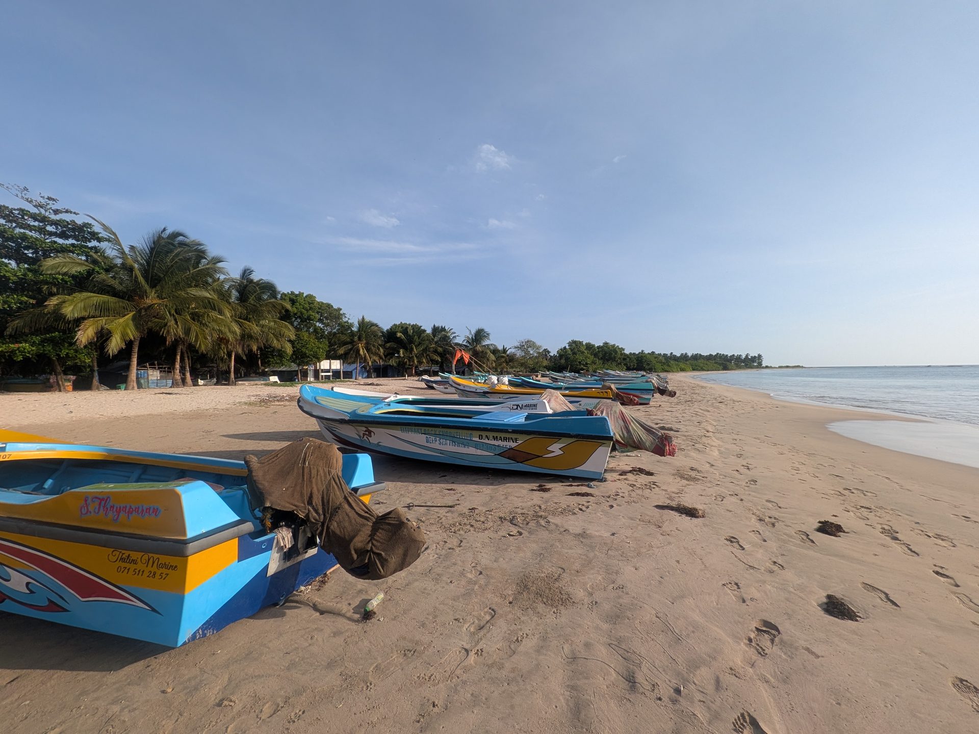 Colorful fishing boats on the sand at Pasikudah