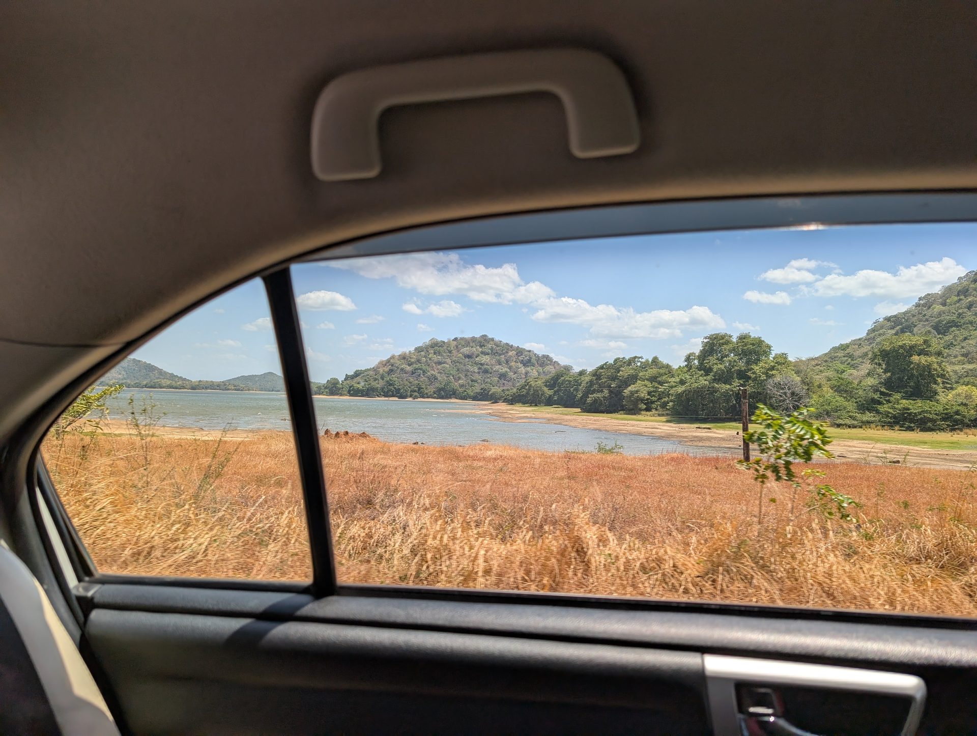Reservoir and hills seen from the car on the drive from Pasikudah