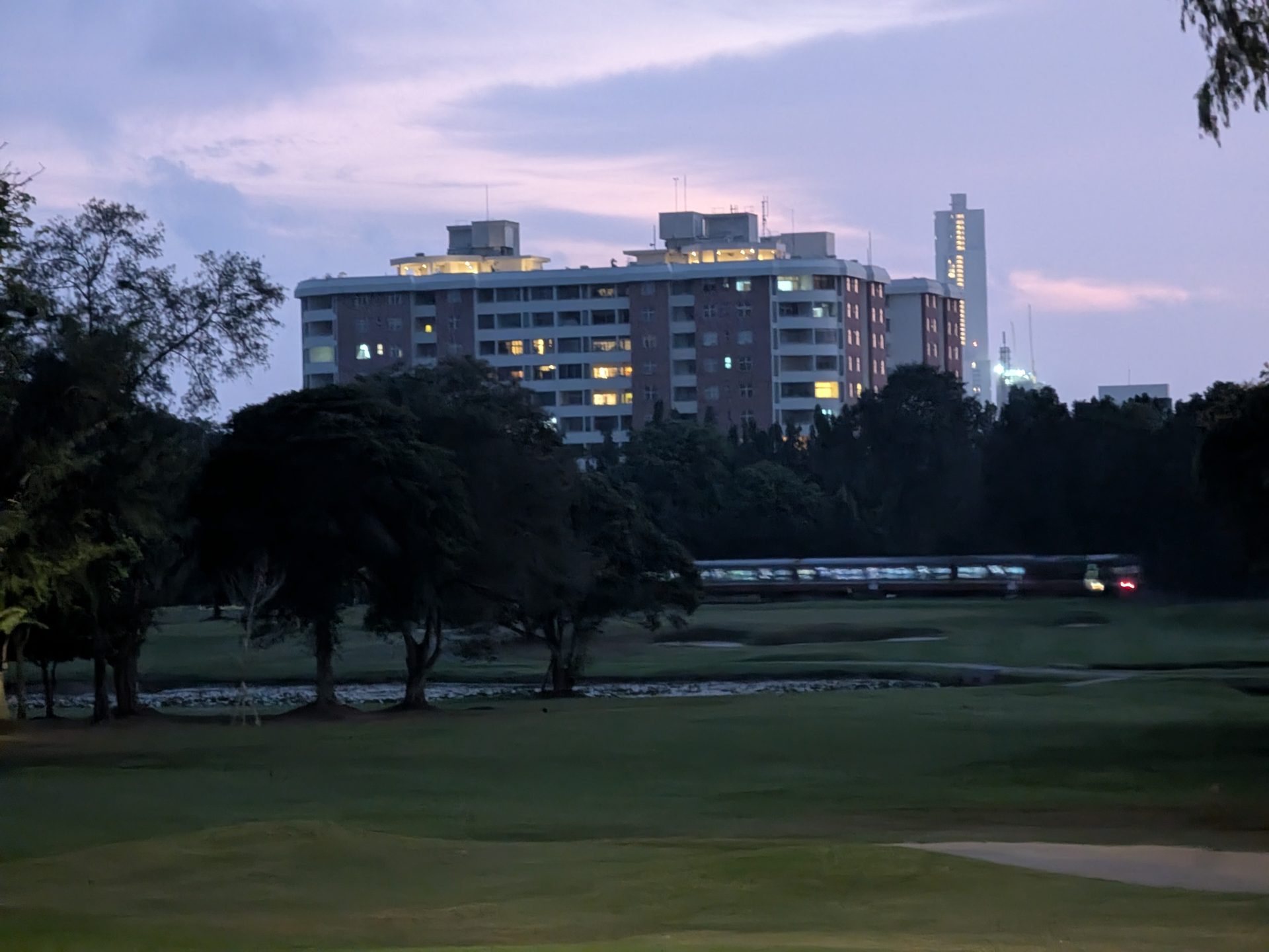 Train passing along a fairway at the Royal Colombo Golf Club at dusk