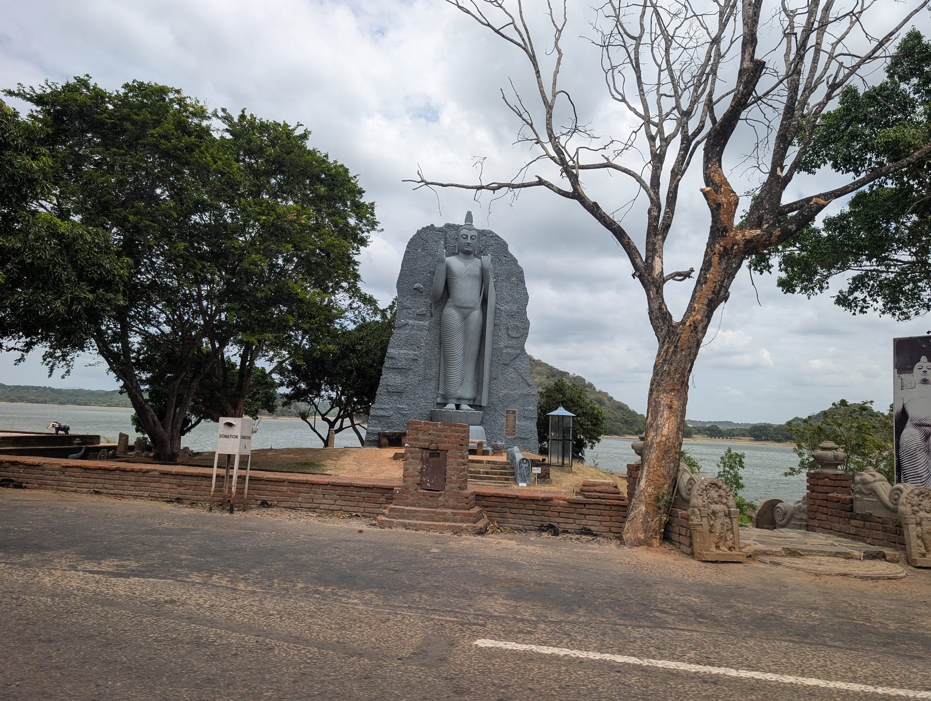 Standing Buddha statue beside Parakrama Samudra