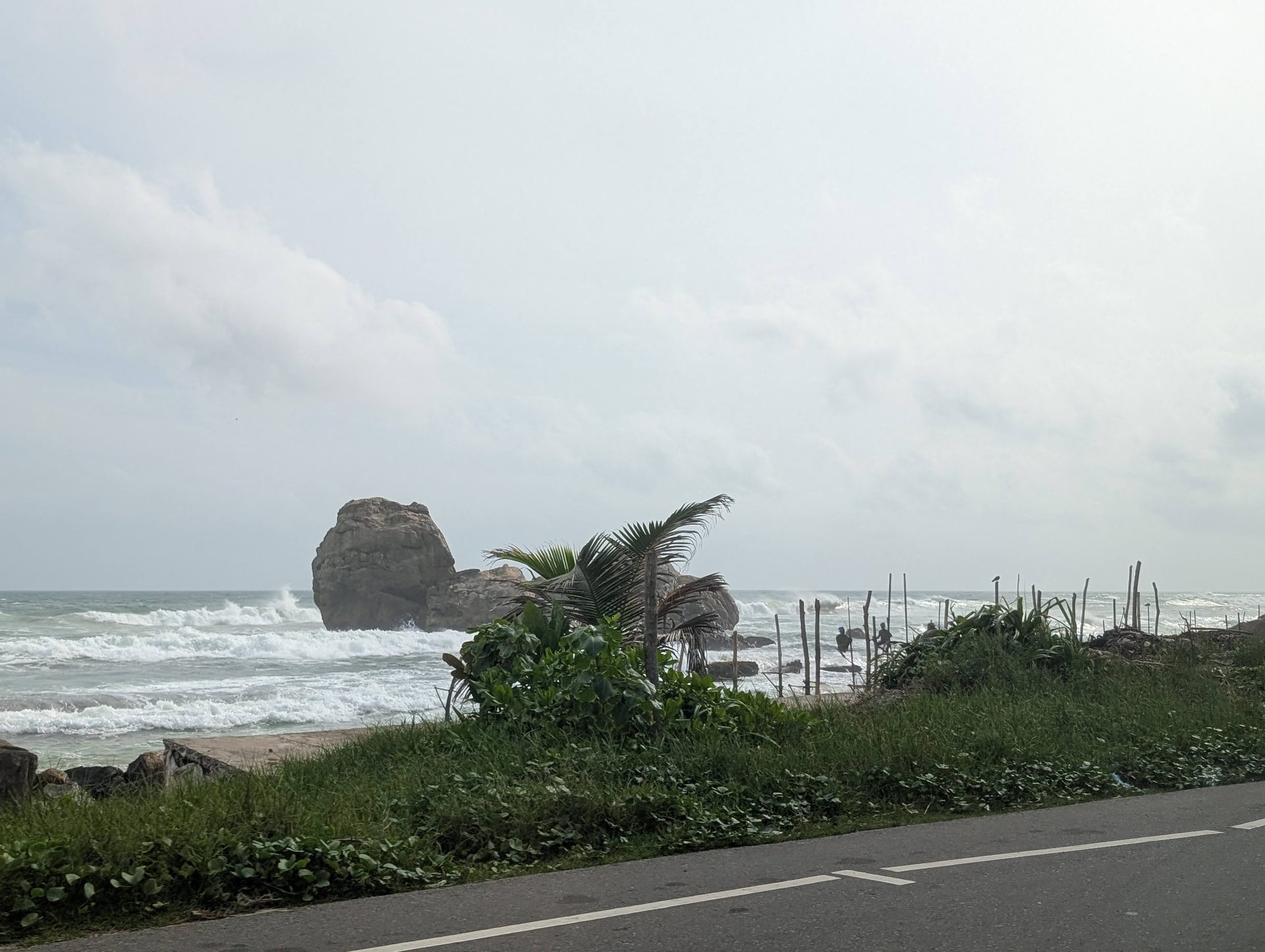 Stilt fishing poles and rocks along the coast near Weligama