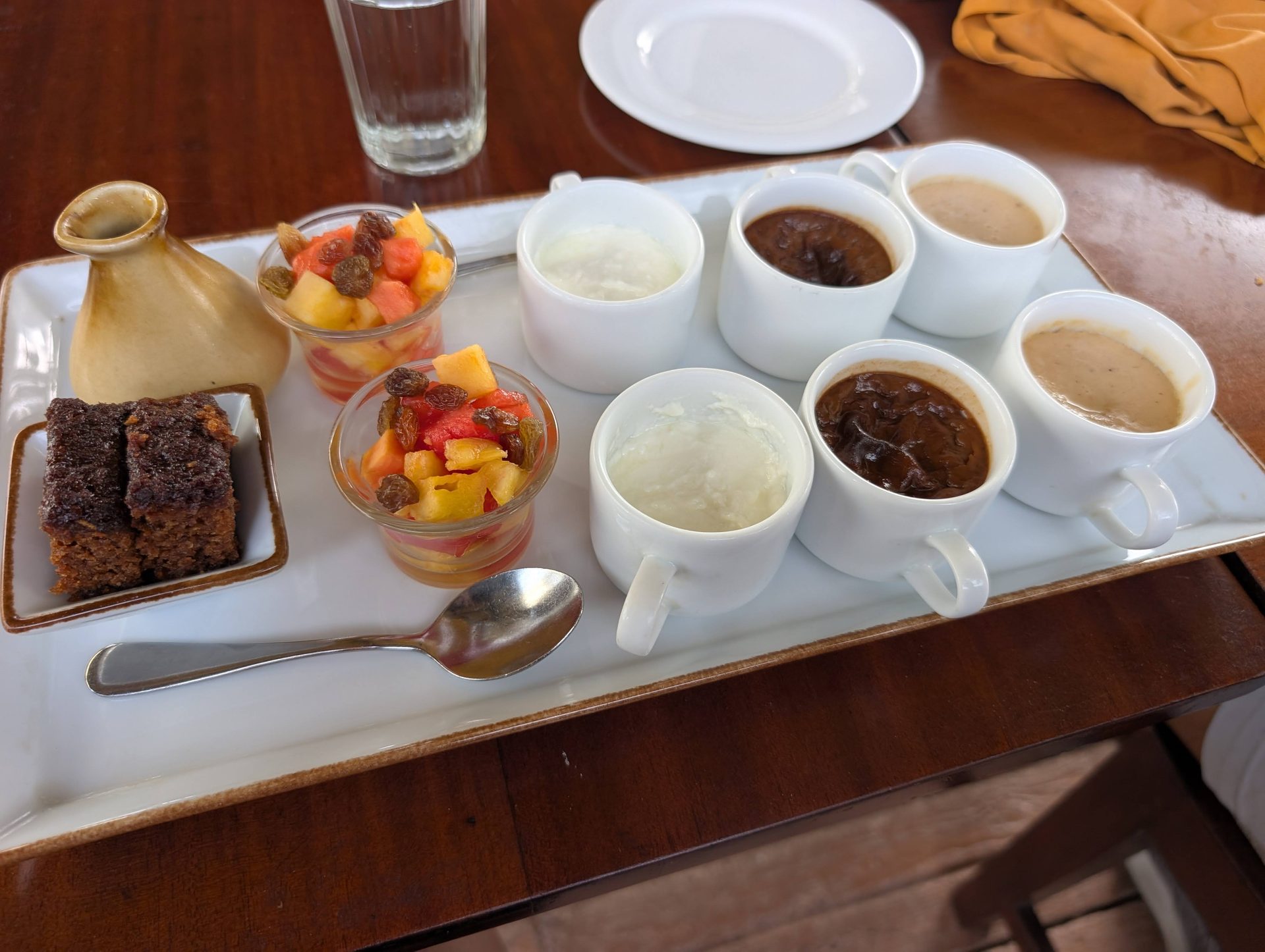 Sri Lankan dessert tray with curd, fruit and cake at Thuna Paha