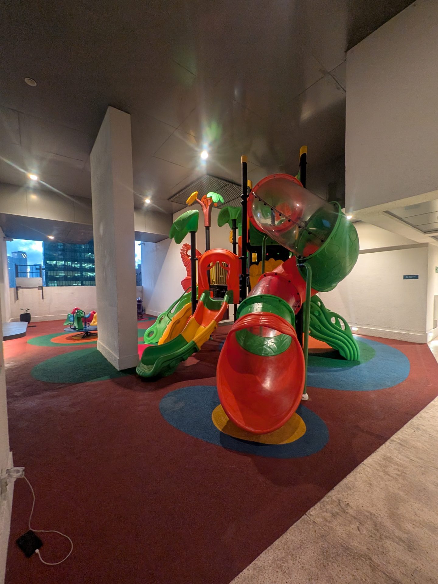 Indoor kids' play area with slides at Tri-Zen