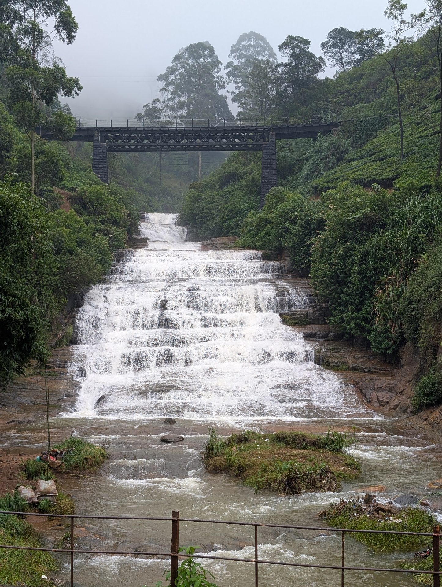 Stepped waterfall under a railway bridge near Nuwara Eliya