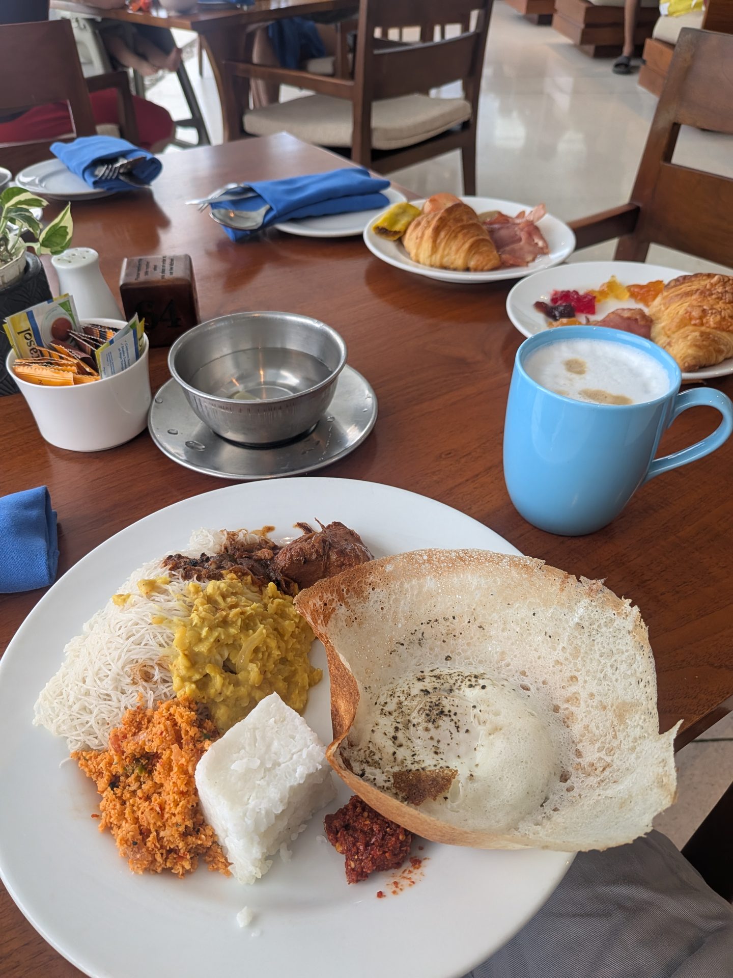 Breakfast plate with hoppers and Sri Lankan dishes at the Weligama Bay Marriott
